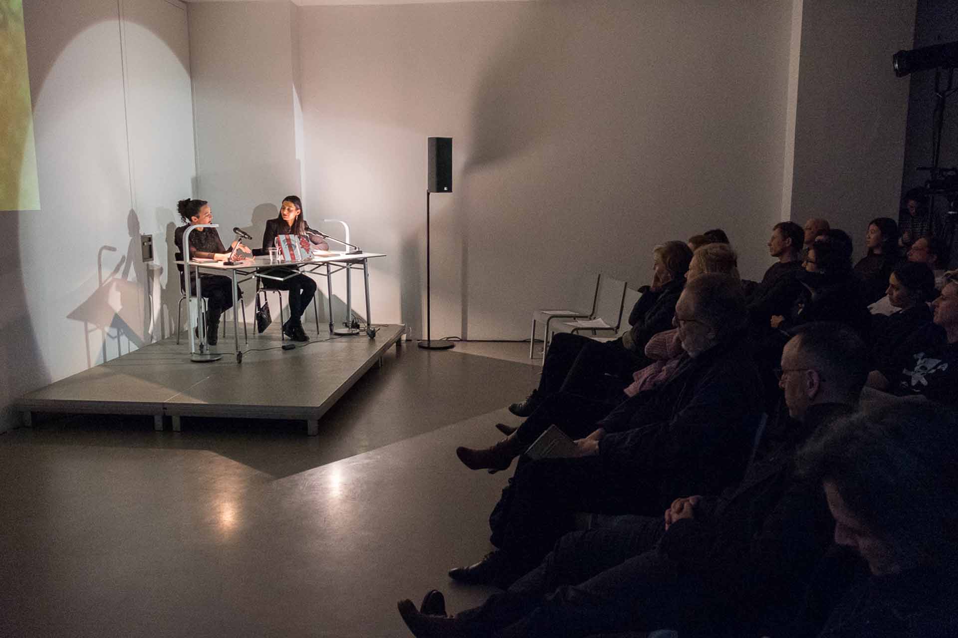 Zielinski.Photography - Images of artworks and culture - Berlin Zielinski and a group of people sitting in front of his artworks projected on a screen, captured through photography.