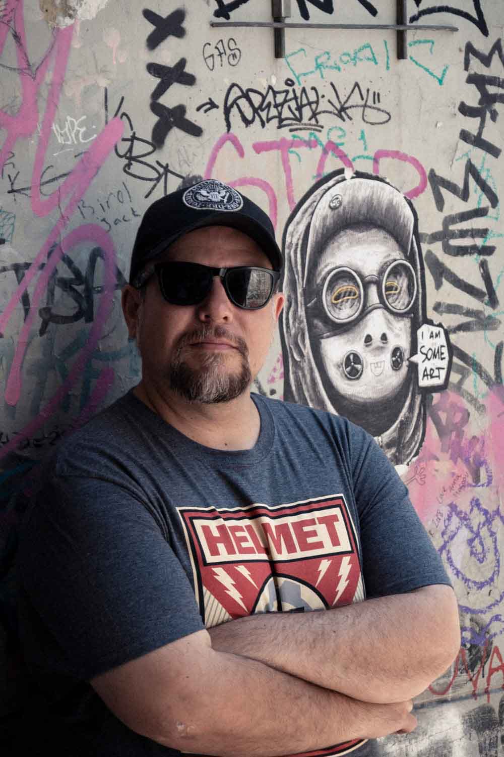 Zielinski.Photography - Images of artworks and culture - Berlin A man performing in front of a wall covered in graffiti.