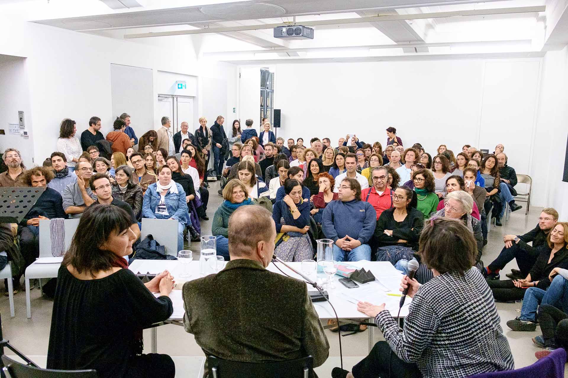 Zielinski.Photography - Images of artworks and culture - Berlin A large group of people immersed in a literature performance.