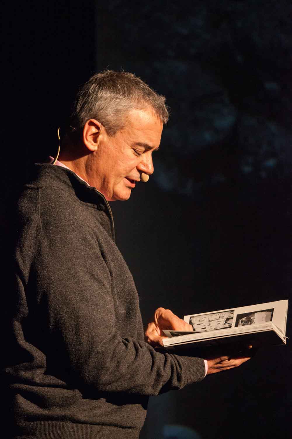 Zielinski.Photography - Images of artworks and culture - Berlin Zielinski holding a book in front of a dark background.