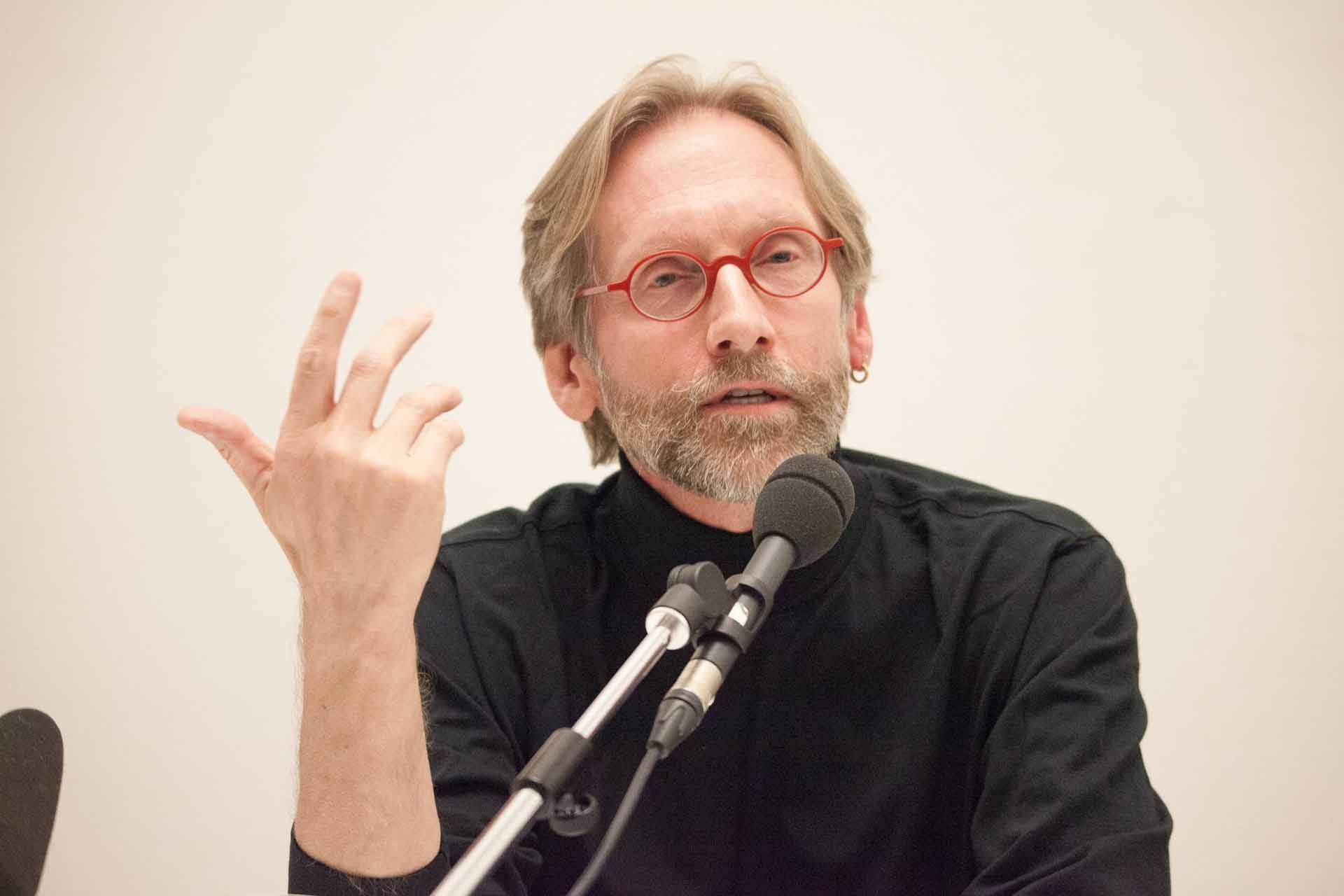 Zielinski.Photography - Images of artworks and culture - Berlin Zielinski, a man with glasses, performing at a microphone during a photography session.