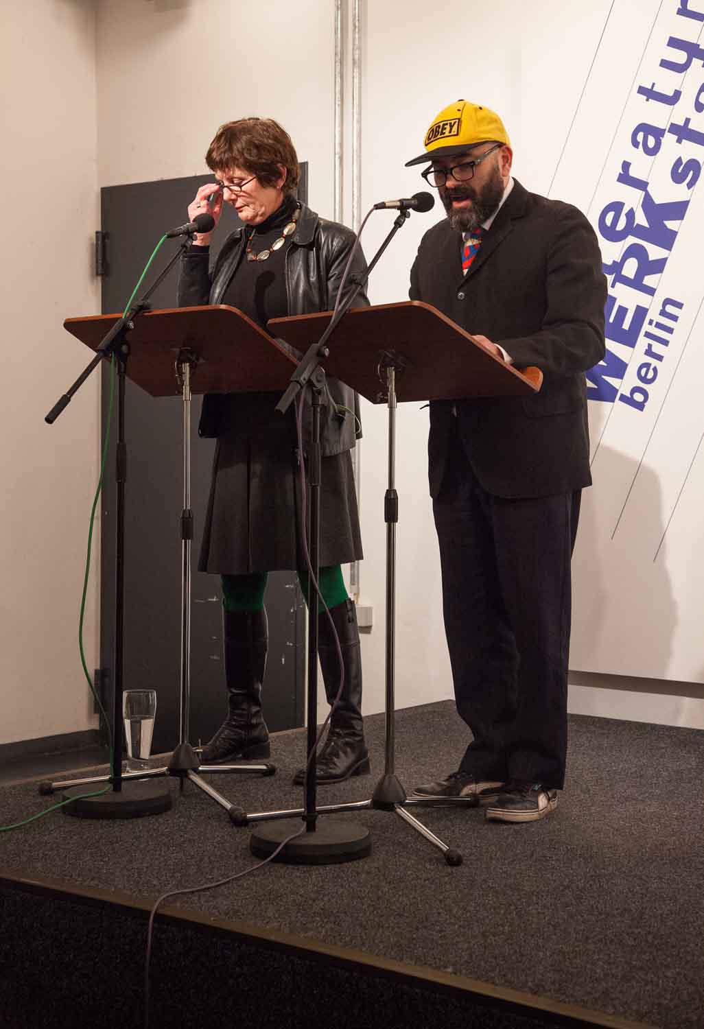 Zielinski.Photography - Images of artworks and culture - Berlin A man and a woman giving a performance in front of a microphone, captured by Zielinski Photography.