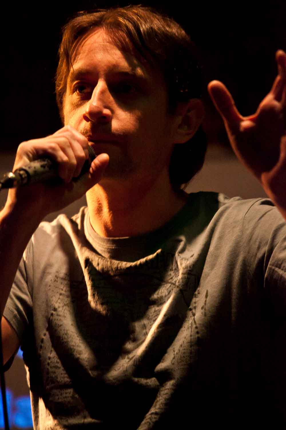 Zielinski.Photography - Images of artworks and culture - Berlin Zielinski is holding a microphone and singing into it while Artworks captures the documentation.