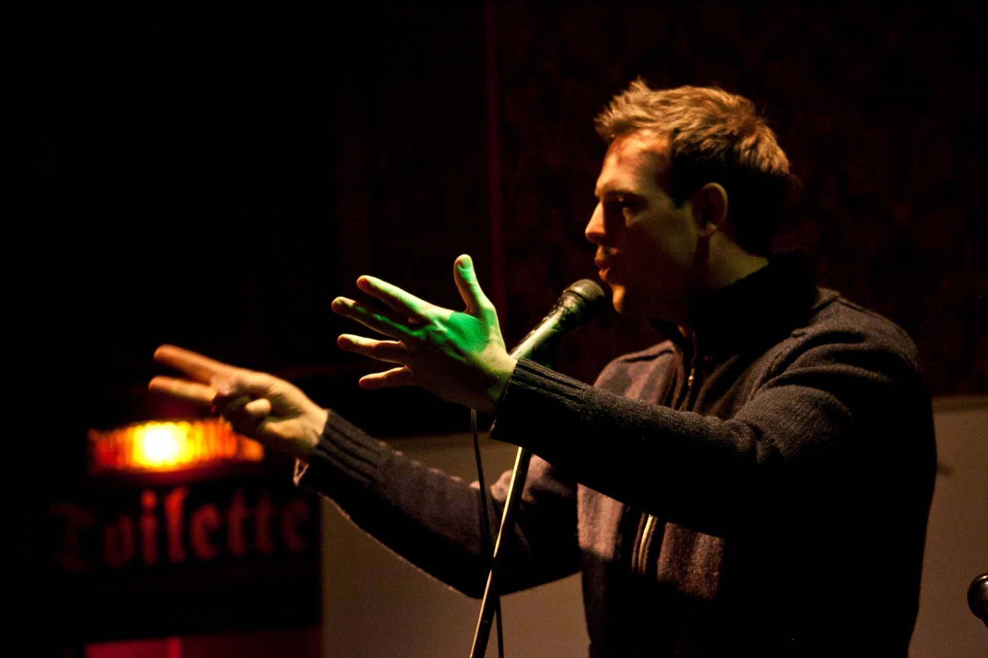 Zielinski.Photography - Images of artworks and culture - Berlin Zielinski is speaking into a microphone in front of a crowd.
