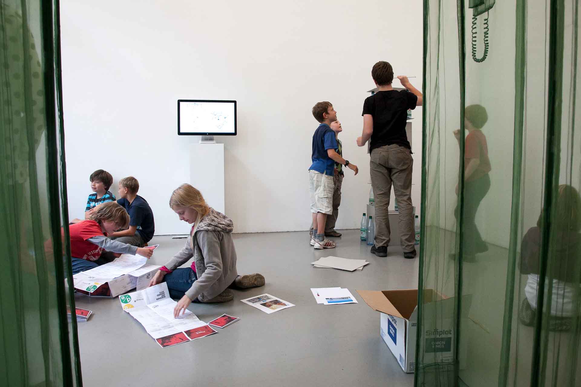 Zielinski.Photography - Images of artworks and culture - Berlin A group of people sitting in a room, focused on the performance aspect and engaging in Zielinski's documentation.