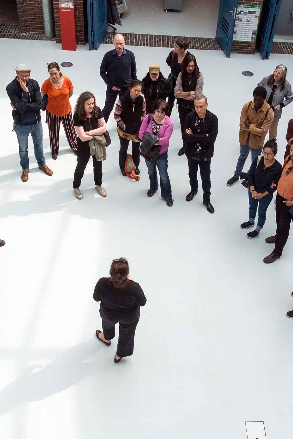 Zielinski.Photography - Images of artworks and culture - Berlin A group of people standing around in a room, engaged in an exhibition.
