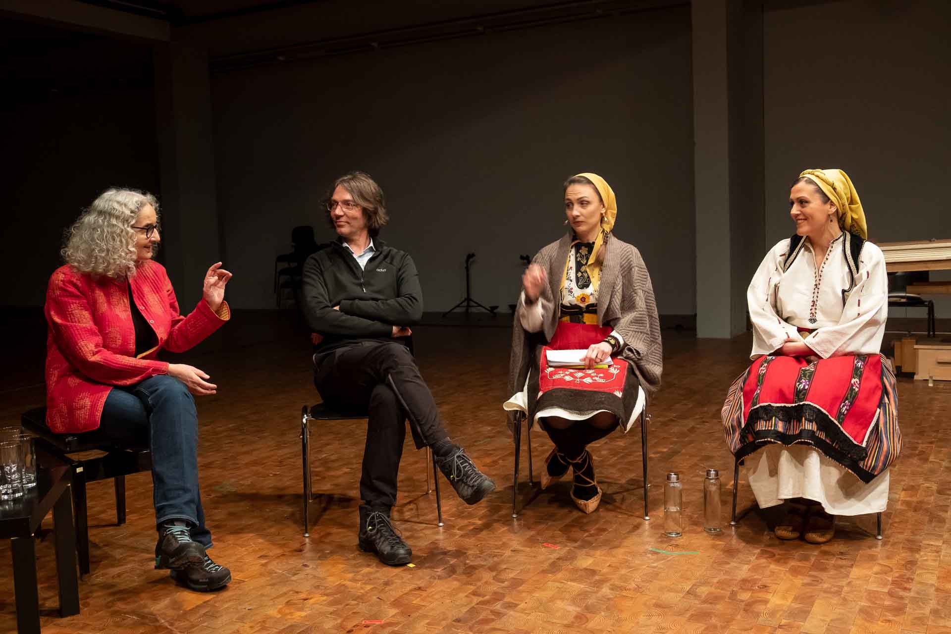 Zielinski.Photography - Images of artworks and culture - Berlin Zielinski and a group of people sitting on chairs in a room, attending an exhibition performance.