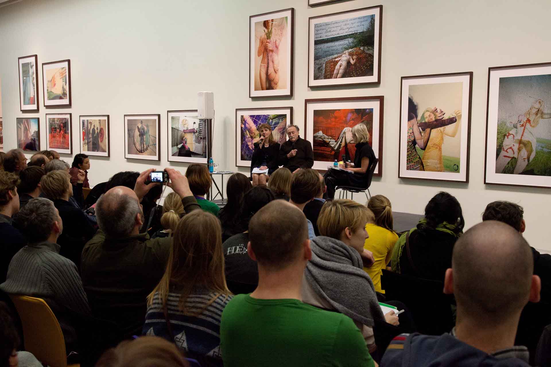 Zielinski.Photography - Images of artworks and culture - Berlin Zielinski and a group of people sitting in front of a large group of pictures.
