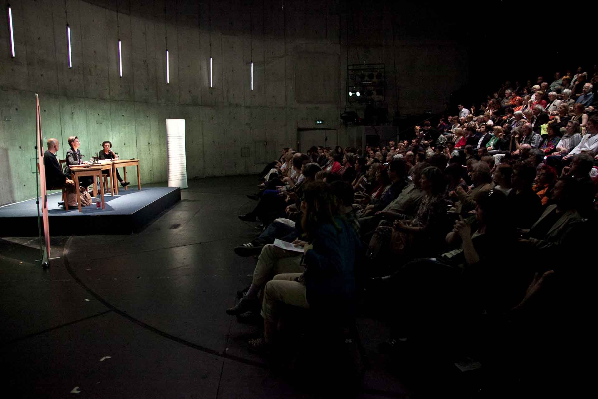 Zielinski.Photography - Images of artworks and culture - Berlin An exhibition showcasing a group of people sitting on a stage in front of an audience admiring artworks by Zielinski.