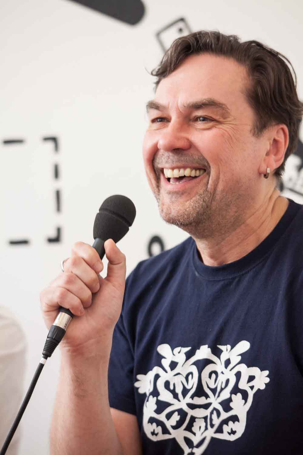 Zielinski.Photography - Images of artworks and culture - Berlin Juri Andruchowytsch is smiling while holding a microphone.